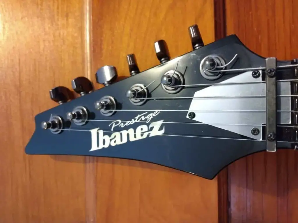 Guitar headstock with tuning pegs and tips of strings